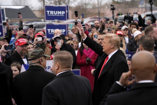 Republican presidential candidate former President Donald Trump greets supporters as he arrives at a campaign stop in Londonderry, N.H., Tuesday, Jan. 23, 2024. (AP Photo/Matt Rourke)
